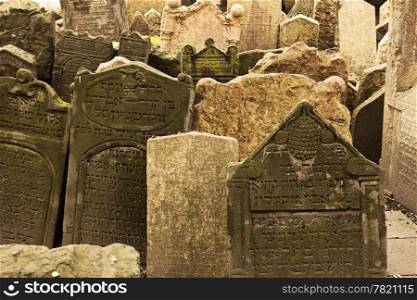 A section of the old Jewish cemetery in the Josefov section of Prague. The many grave markers are jumbled together in an uneven pattern due to the age of the stones and the settling of the ground.