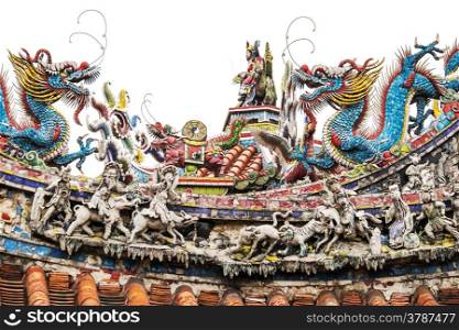 A section of the roof of the Mengjia Longshan Buddhist Temple in Taipei, Taiwan shows a series of highly decorative sculptures, including dragons and other creatures, in addition to other colorful shapes.