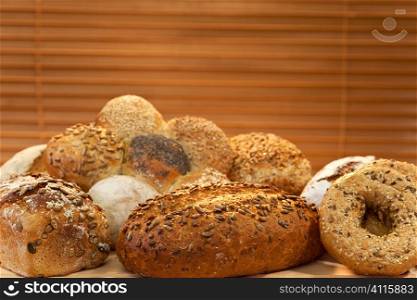 A selection of rustic, wholemeal and seeded handmade breads shot in golden sunlight