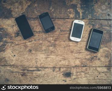 A selection of smart phones on a wooden table