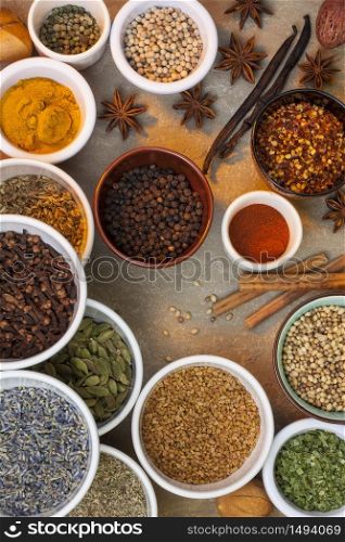 A selection of spices used in cooking - cinnamon, lavender, cardamon, chilli, star anise, peppers, turmeric, dill, vanilla etc.