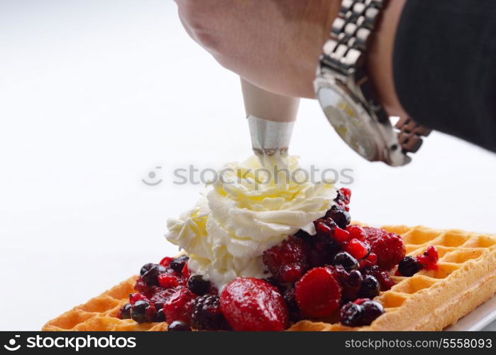 a selection of three italian gelato ice-cream scoops topped with nuts, chocolate, fruit served on crispy waffels