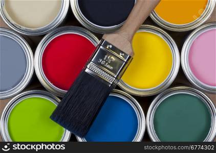 A selection of tins of colorful emulsion paint.