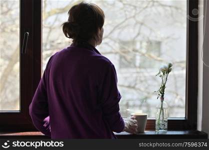 A Self-isolate Woman or Quarantine Looking Out Window Home