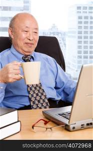 A senior asian businessman working in the office