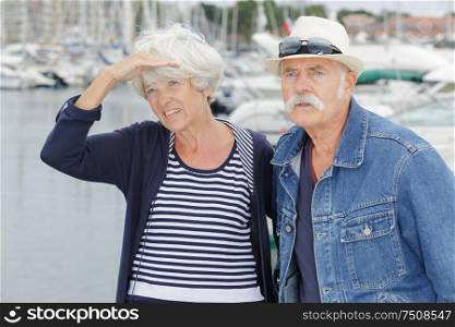 a senior couple at harbour