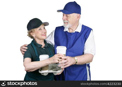 A senior couple enjoying a work break with some coffee. Isolated on white.
