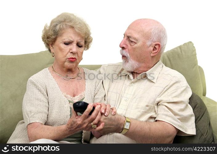 A senior couple fighting over the television remote control. White background.