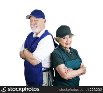A senior couple unable to retire and working service industry jobs. Isolated on white.