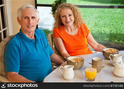 A senior man and woman couple enjoying a healthy breakfast together after retirement