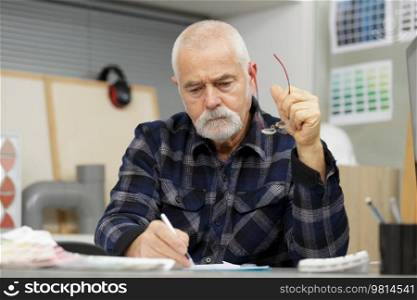 a senior man in a workshop