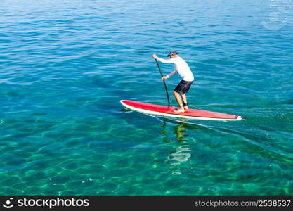 A senior man practicing paddle on a beautiful sunny day