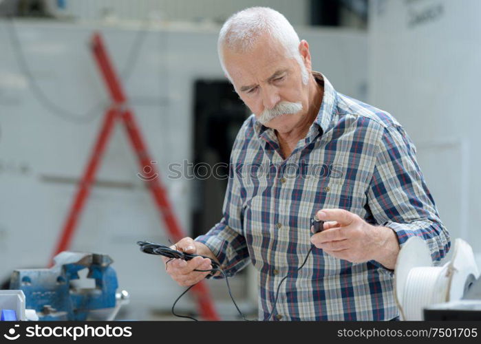 a senior technician using screwdriver