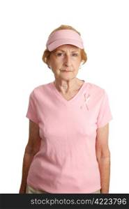 A senior woman in pink with a breast cancer awareness ribbon. She&rsquo;s serious about beating the disease.