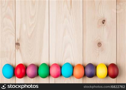 a series Easter eggs and a wooden background for an inscription