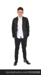 A serious looking teen boy standing with his hands in his pocket, in a black jacket and pants, isolated for white background