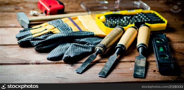 A set of construction tools on the table. On a wooden background. High quality photo. A set of construction tools on the table.