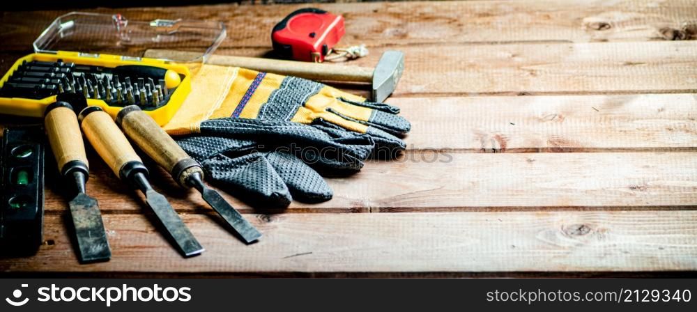A set of construction tools on the table. On a wooden background. High quality photo. A set of construction tools on the table.