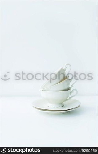 A set of cream porcelain cups with saucers on the table, preparation for the tea ceremony, top view. A set of cream porcelain cups with saucers on the table, preparation for the tea ceremony, top view.