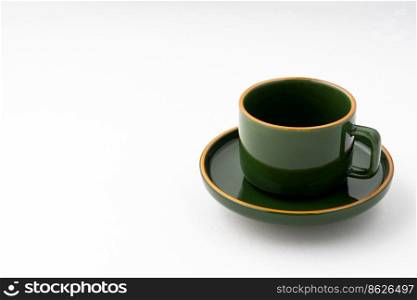 A set of green ceramic plate and coffee mug on a white background. Set of green ceramic plate and coffee mug on a white background