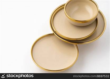 A set of light brown ceramic plate and bowl on a white background. Set of light brown ceramic plate and bowl on a white background