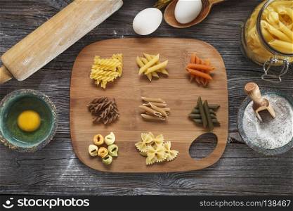 A set of raw pasta on a wooden desk. A set of raw pasta on a wooden table. Studio Shot