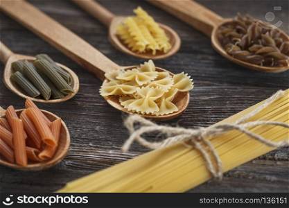 A set of raw pasta on a wooden table. A set of raw pasta on a wooden table. Studio Shot