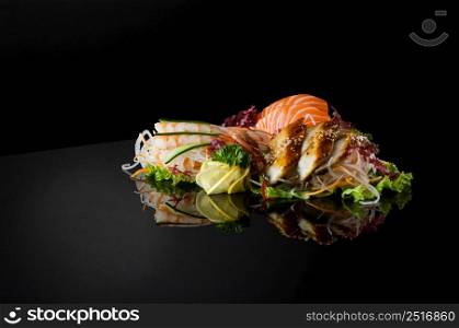 a set of sushi with shrimps on a black background with reflection. sushi on black background