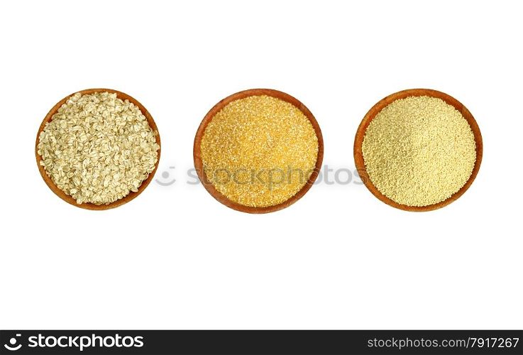 A set of three types of cereals on a brown plate (millet, maize and cereal).