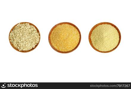 A set of three types of cereals on a brown plate (millet, maize and cereal).