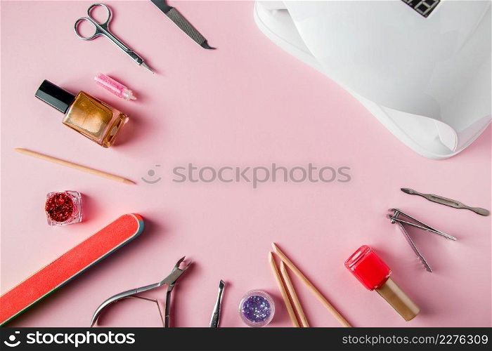 A set of tools for manicure and nail care on a pink background. Workplace in a beauty salon. Place for text.. A set of tools for manicure and nail care on pink background. Workplace in a beauty salon. Place for text.