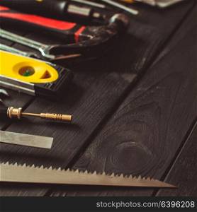 A set of tools laid out in a semicircle on top of the wooden table with copy space. Set of tools for real professional