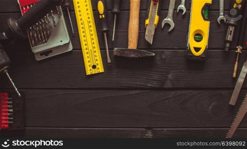 A set of tools laid out in a semicircle on top of the wooden table with copy space. Set of tools for real professional