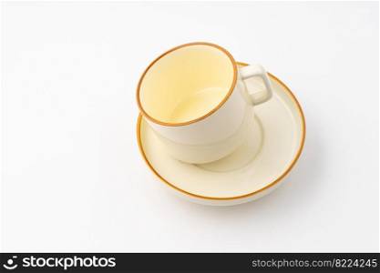 A set of white and brown ceramic plate and cup on a white background. Set of white and brown ceramic plate and cup on a white background