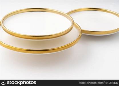 A set of white and brown ceramic plates on a white background. Set of white and brown ceramic plates on a white background
