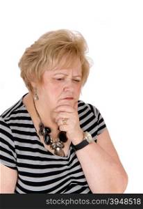 A seventy year old woman with one hand on her chin thinking hard abouther problems, isolated for white background.