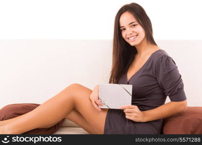 A sexy asian woman lying on her couch with a gift - Christmas or Birthday concept