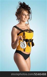 A sexy photo of flirting pin-up girl in vintage corset holding alarm clock.