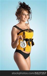 A sexy photo of flirting pin-up girl in vintage corset holding alarm clock.