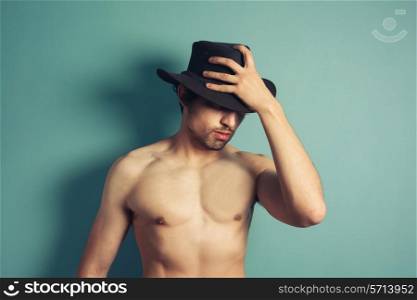 A sexy shirtless young man is wearing a cowboy hat