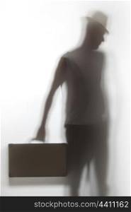 A shadow of a man holding a briefcase.