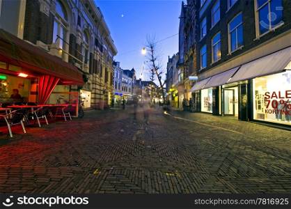 A shopping street with christmas decorations at dusk