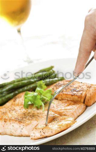 A shot of a baked salmon with string beans
