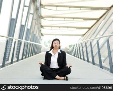A shot of a beautiful black businesswoman meditating