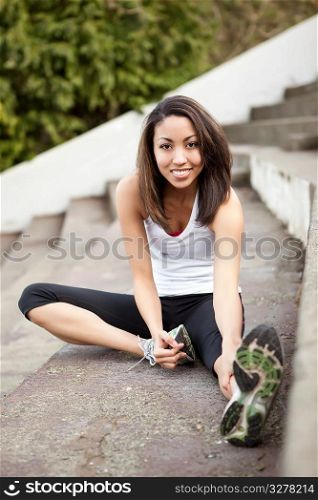 A shot of a beautiful black woman exercises outdoor
