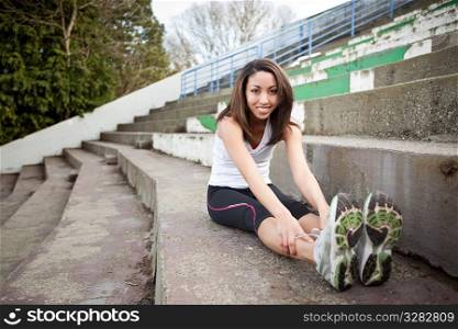 A shot of a beautiful black woman exercises outdoor