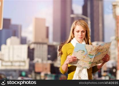 A shot of a beautiful caucasian traveling woman reading a map