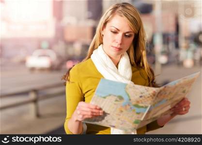 A shot of a beautiful caucasian traveling woman reading a map