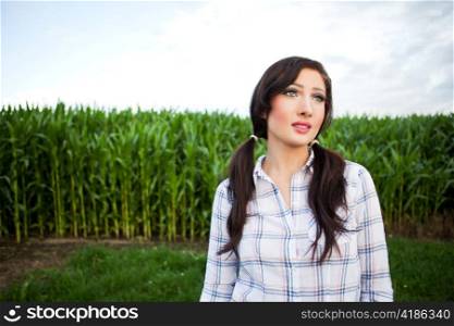 A shot of a beautiful farm girl near the corn field