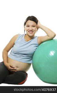 A shot of a beautiful pregnant asian woman with exercise ball